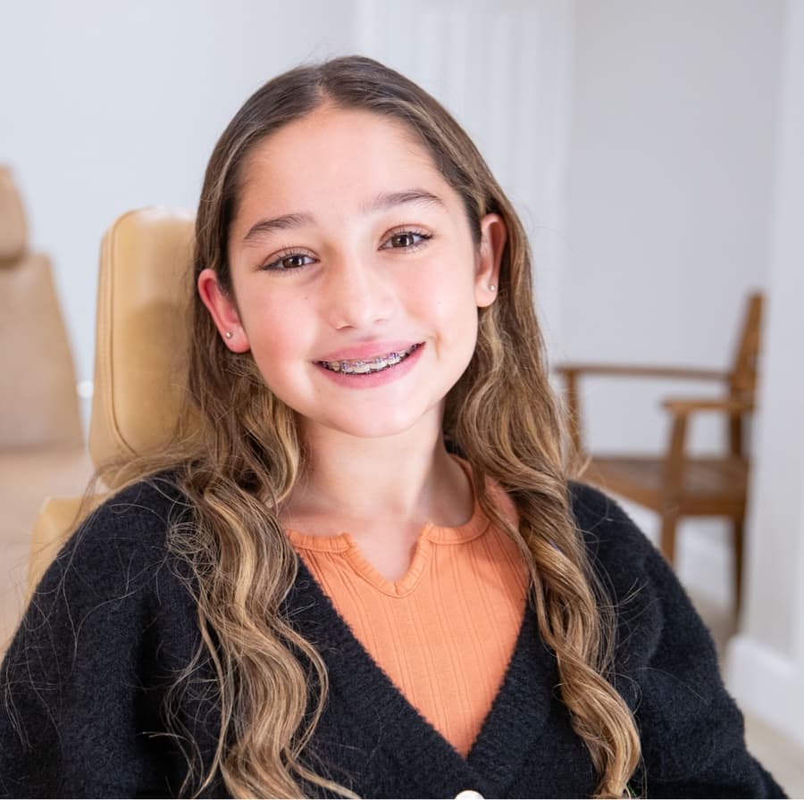 young girl wearing braces smiling